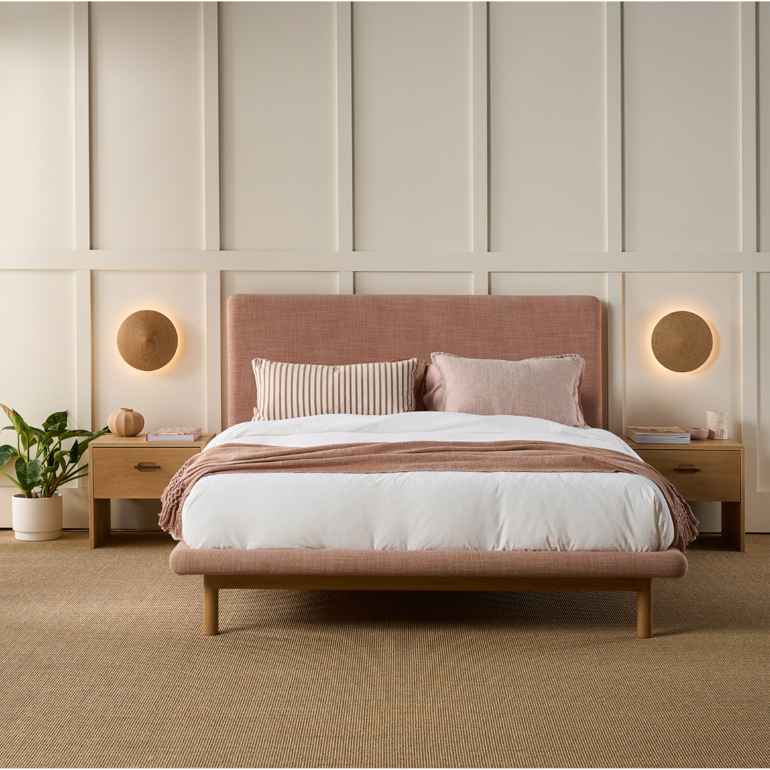 Zoe upholstered bed with solid timber frame contour, in a styled bedroom, paired with Ayda bedside table.